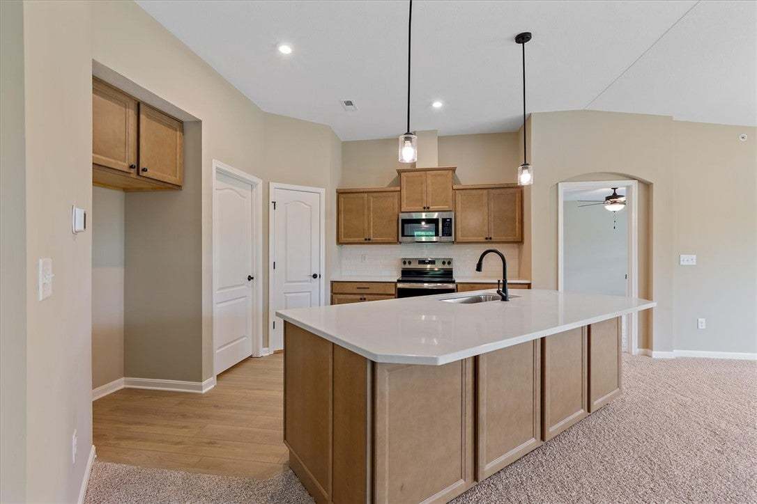 This new kitchen features an island, ample cabinet