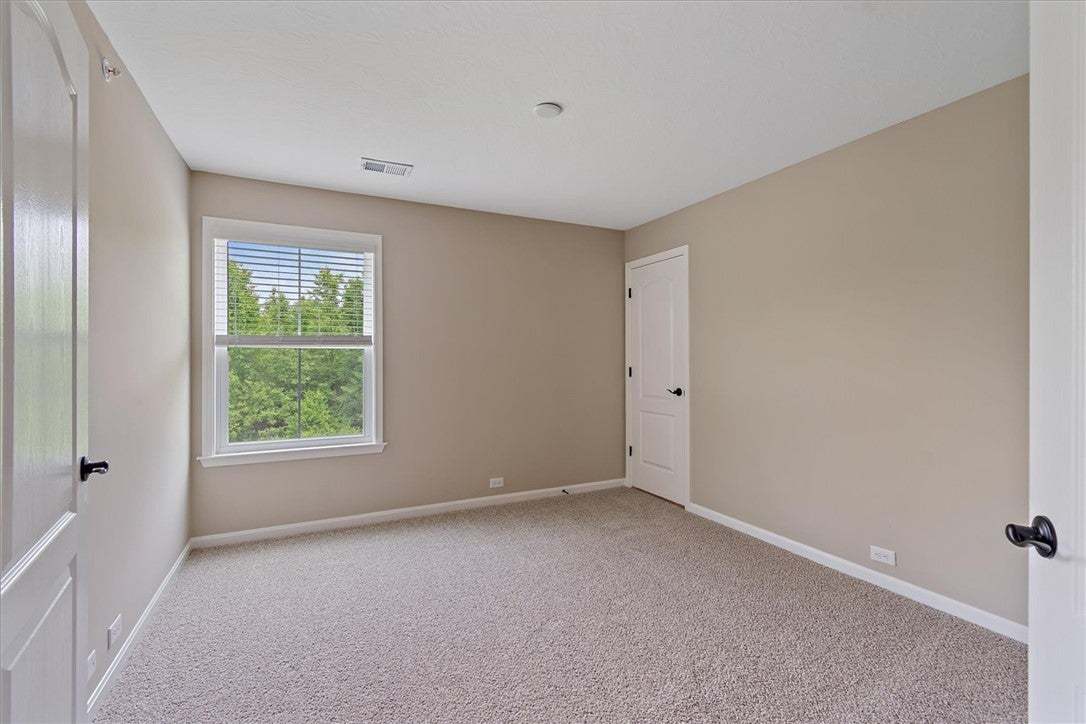 This naturally illuminated bedroom offers peaceful