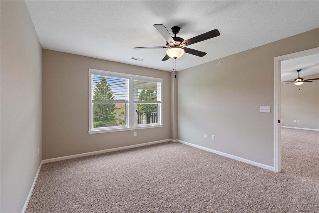 This naturally illuminated bedroom offers carpeted