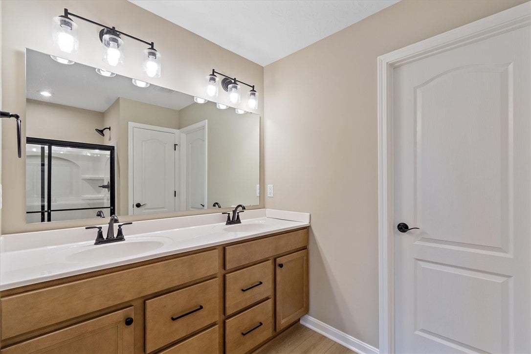 This primary bathroom features a double vanity wit