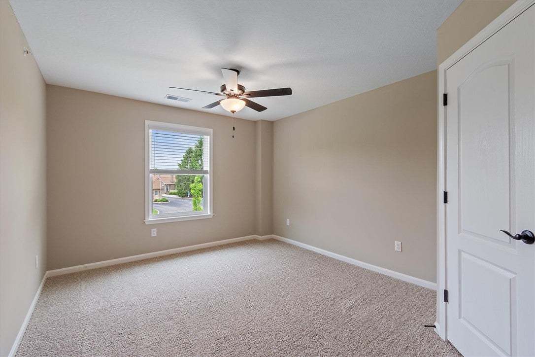 A well-proportioned bedroom with a window overlook