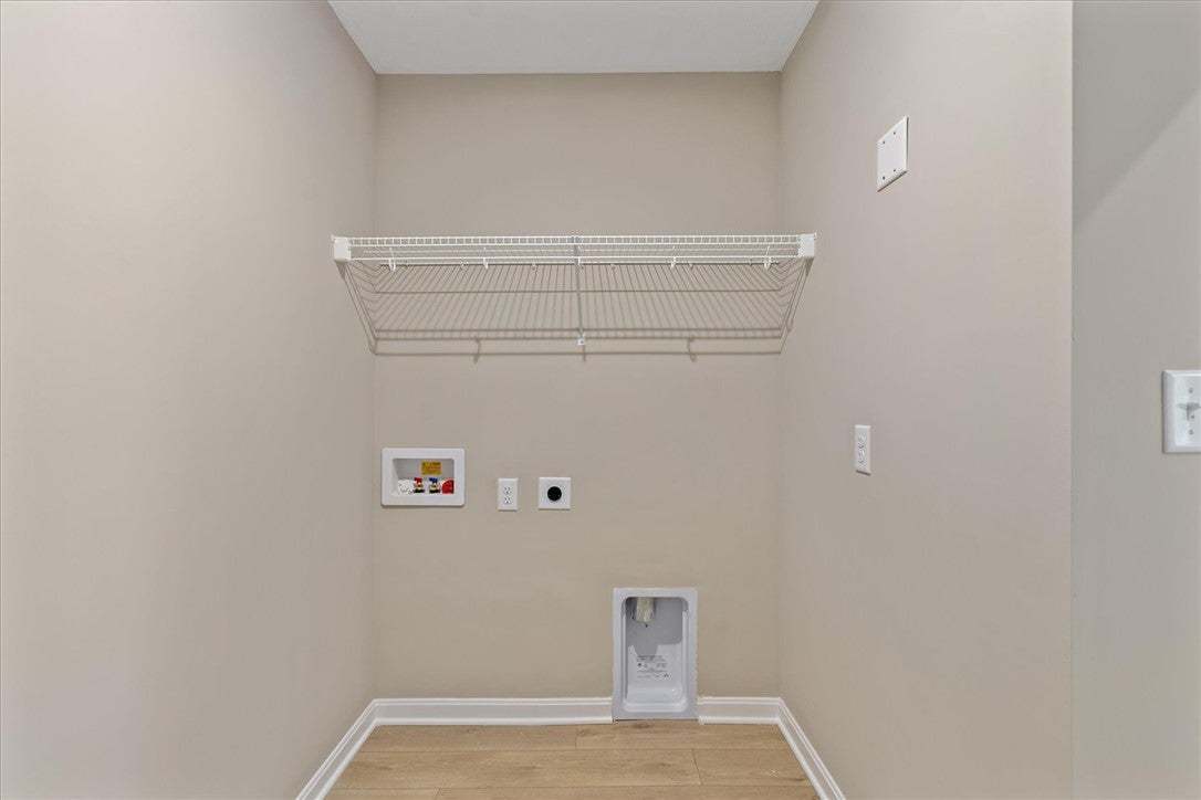 This dedicated laundry space offers practical util