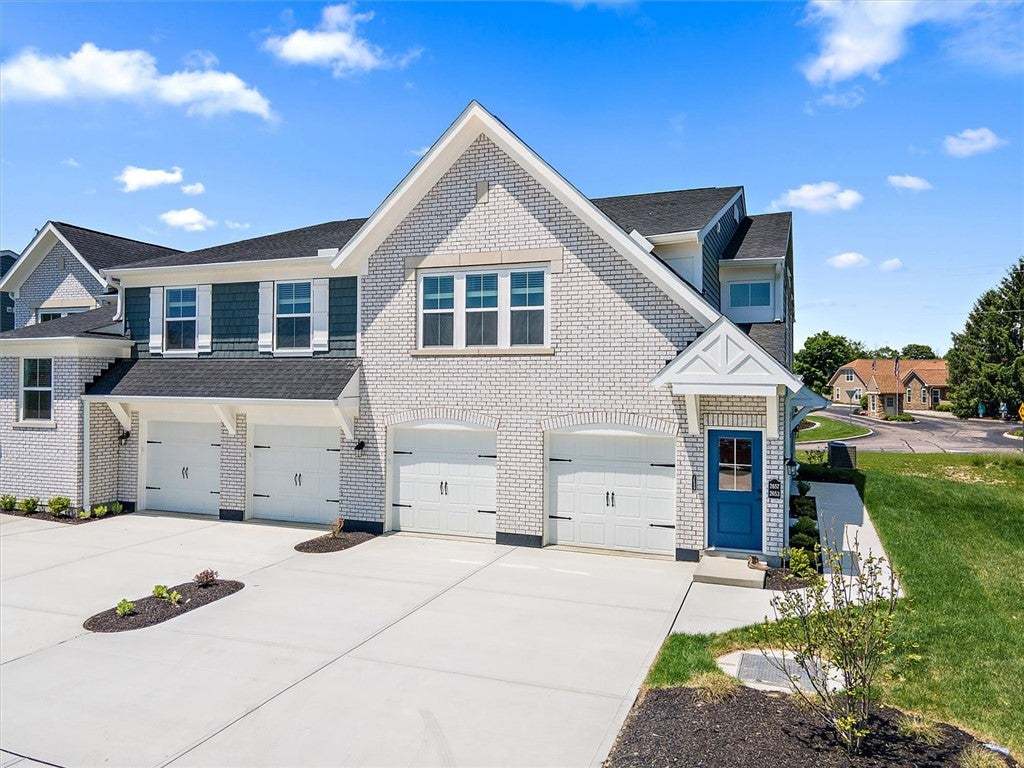 Newly constructed townhome with a bright blue fron