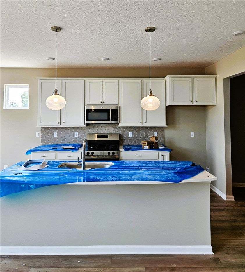 Rich wood-look flooring and custom cabinetry ancho