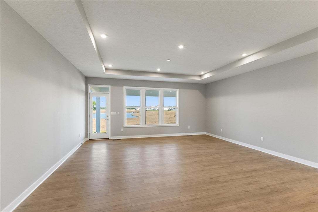This living area features a decorative tray ceilin