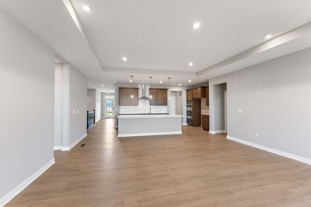 An open-concept living area flows into a kitchen w