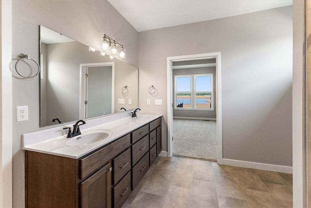 This spacious bathroom offers a double vanity and