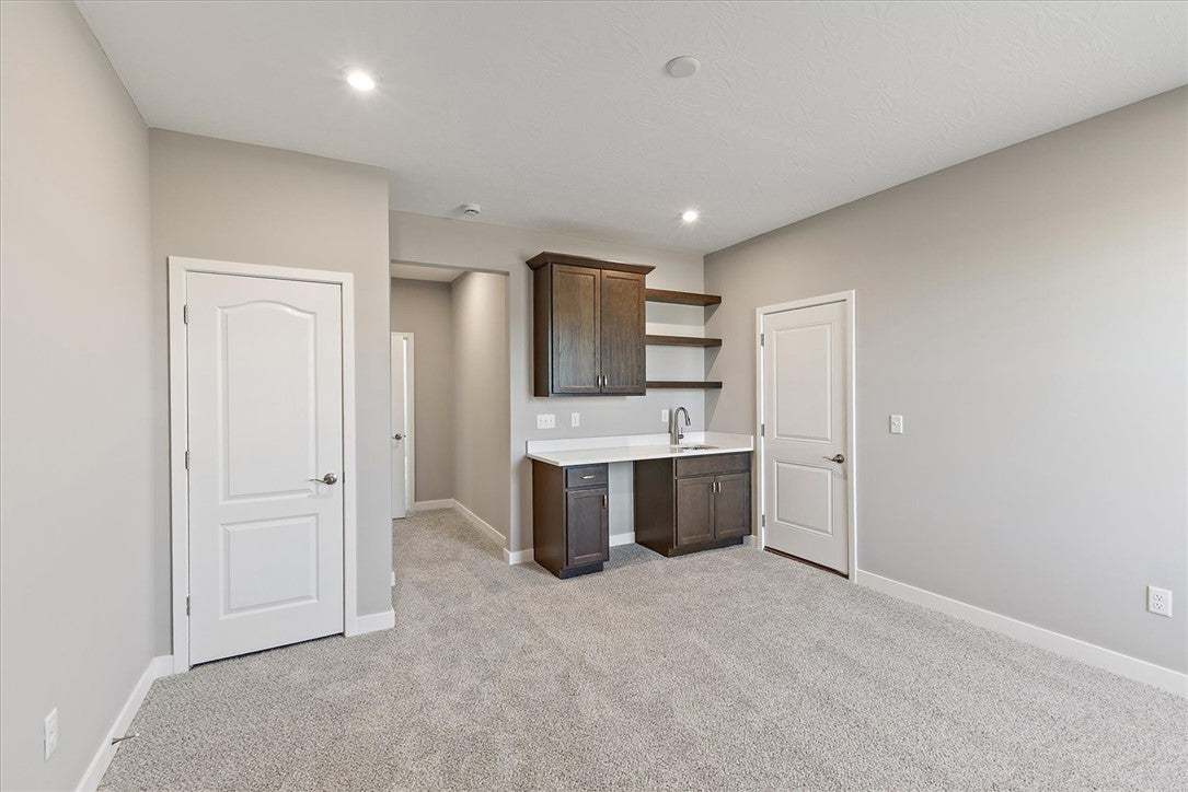 This versatile room features a wet bar with cabine