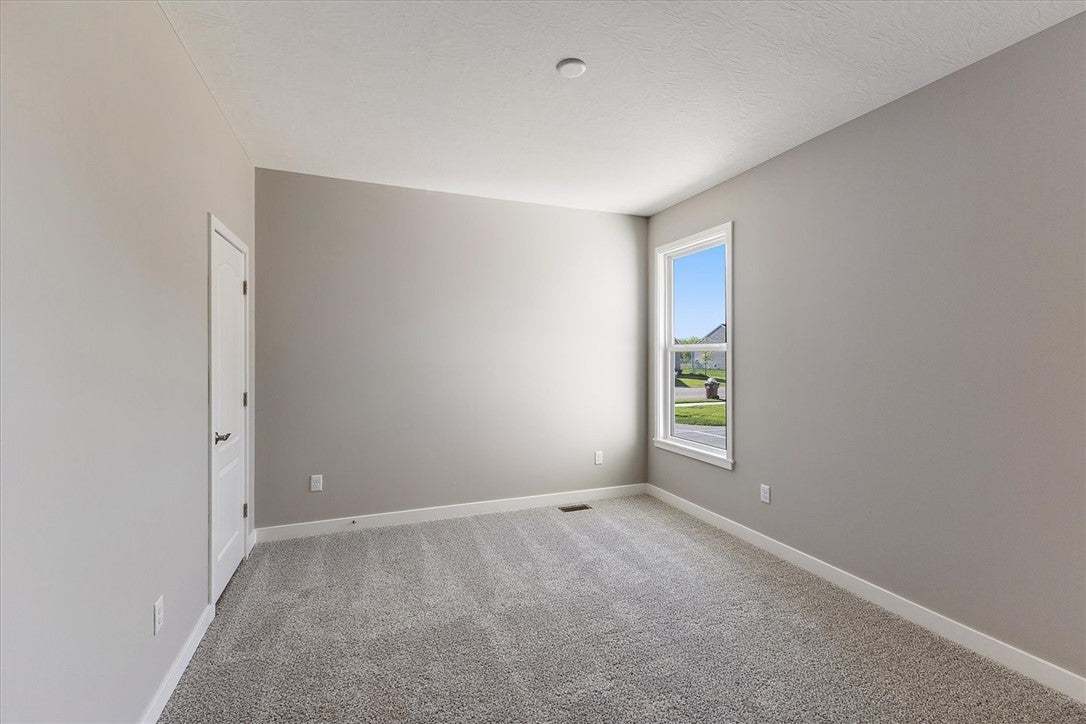 A well-proportioned bedroom with soft gray walls a