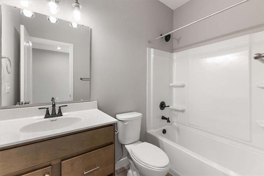 This functional bathroom features a single vanity,