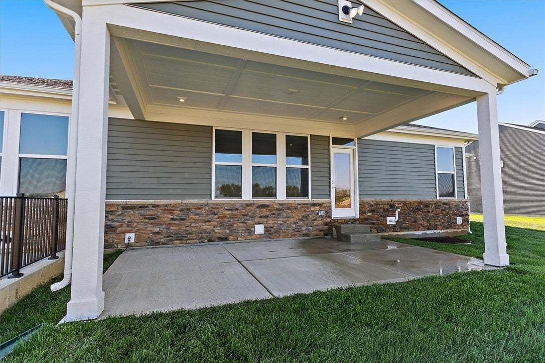 This newly constructed home features a covered pat