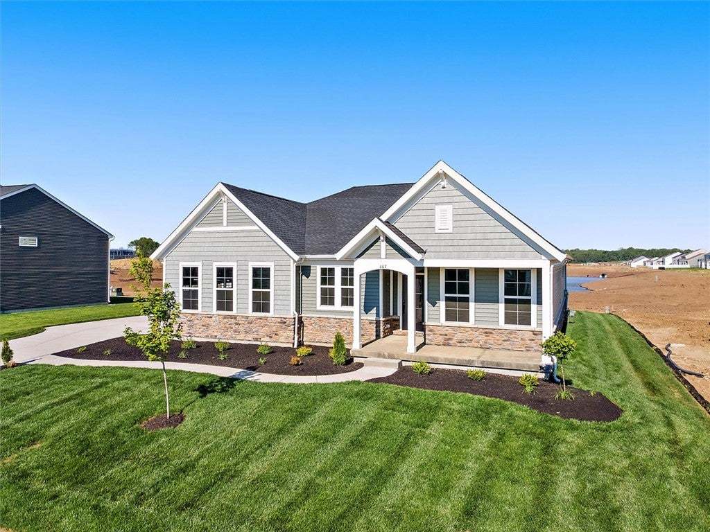 Crafted with stone and siding, this charming resid