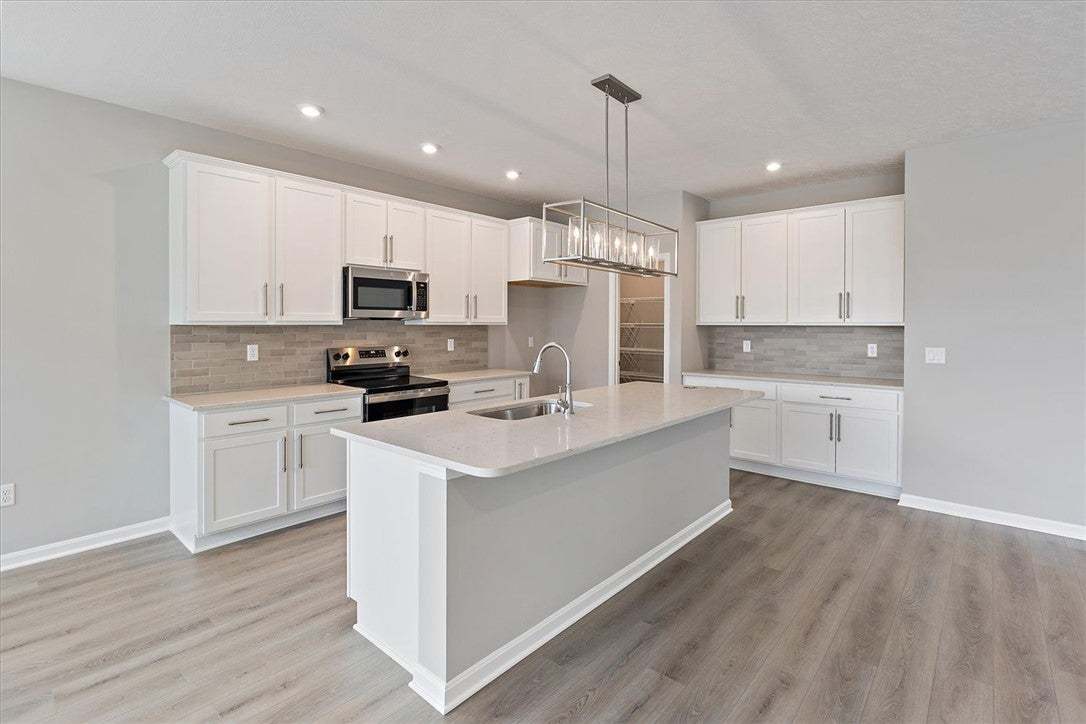 This bright kitchen features sleek appliances, an