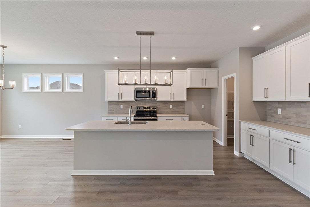 This spacious kitchen features an island, ample ca