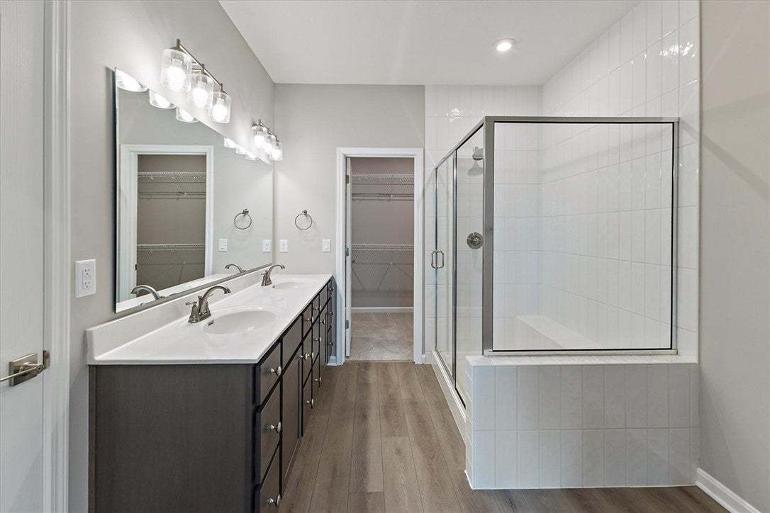This spacious bathroom offers dual vanities and a