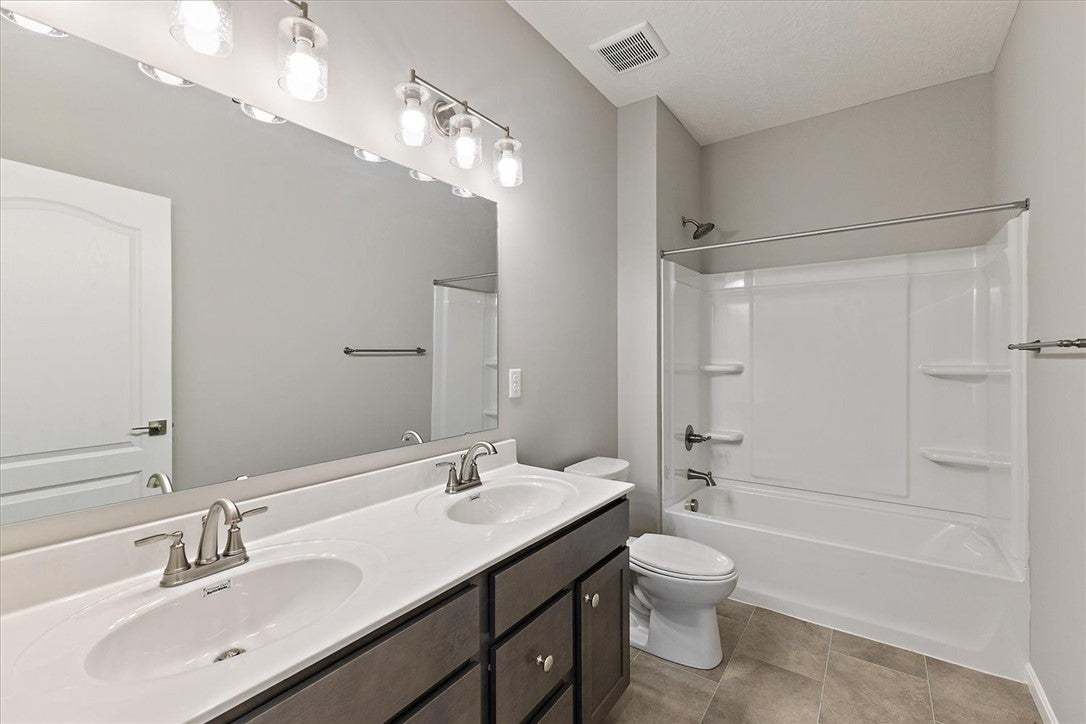 This modern bathroom features a double vanity and