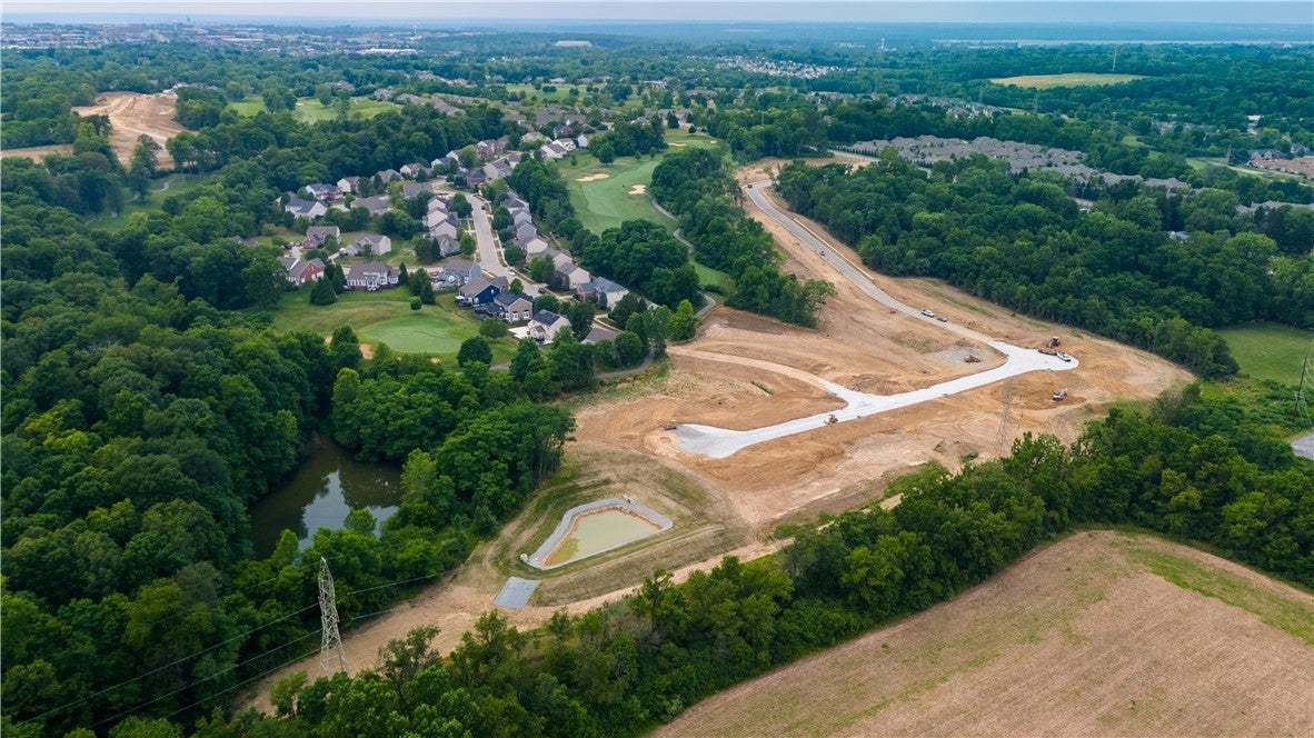 A vast aerial view reveals a developing neighborho