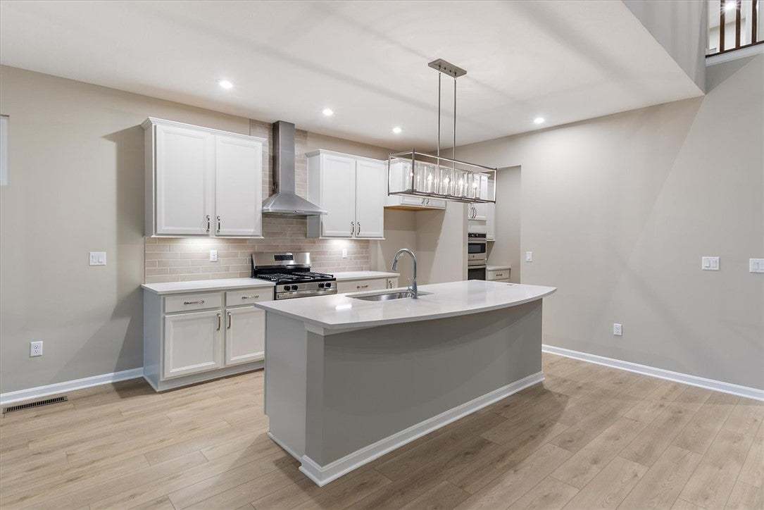 Warm wood-look flooring and clean white cabinetry