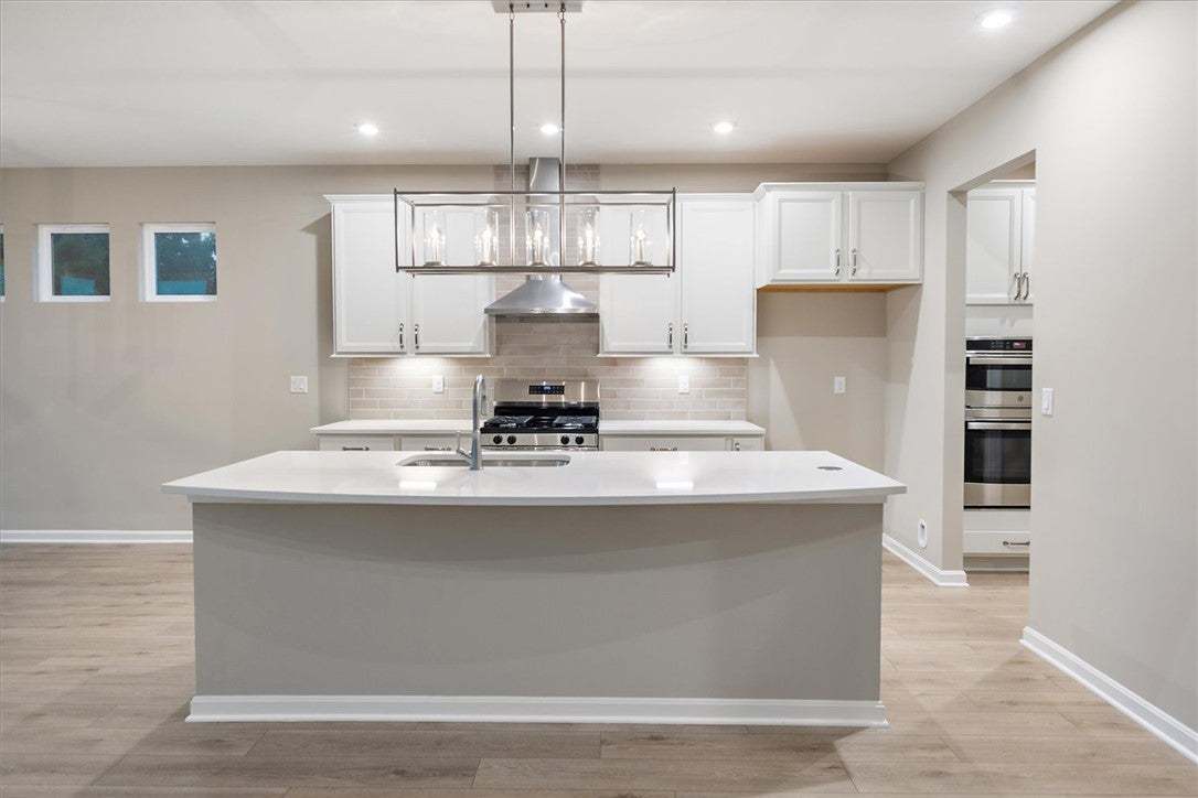 A spacious kitchen centered around a large functio