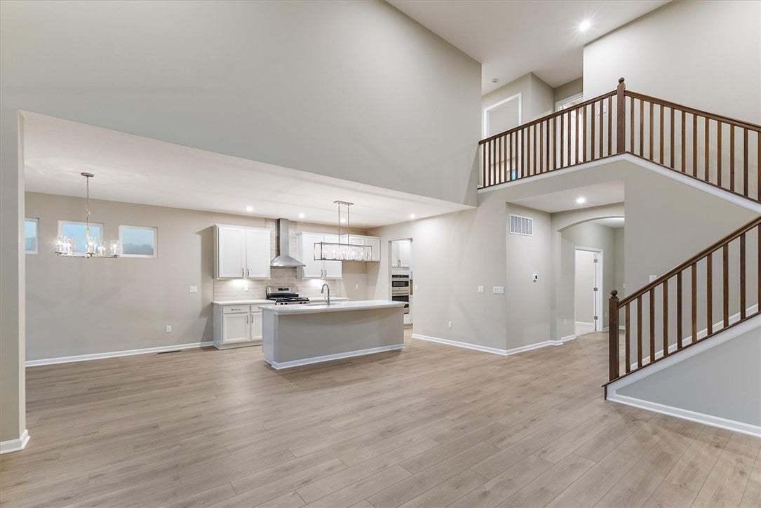 Soaring ceilings and a spacious open layout connec