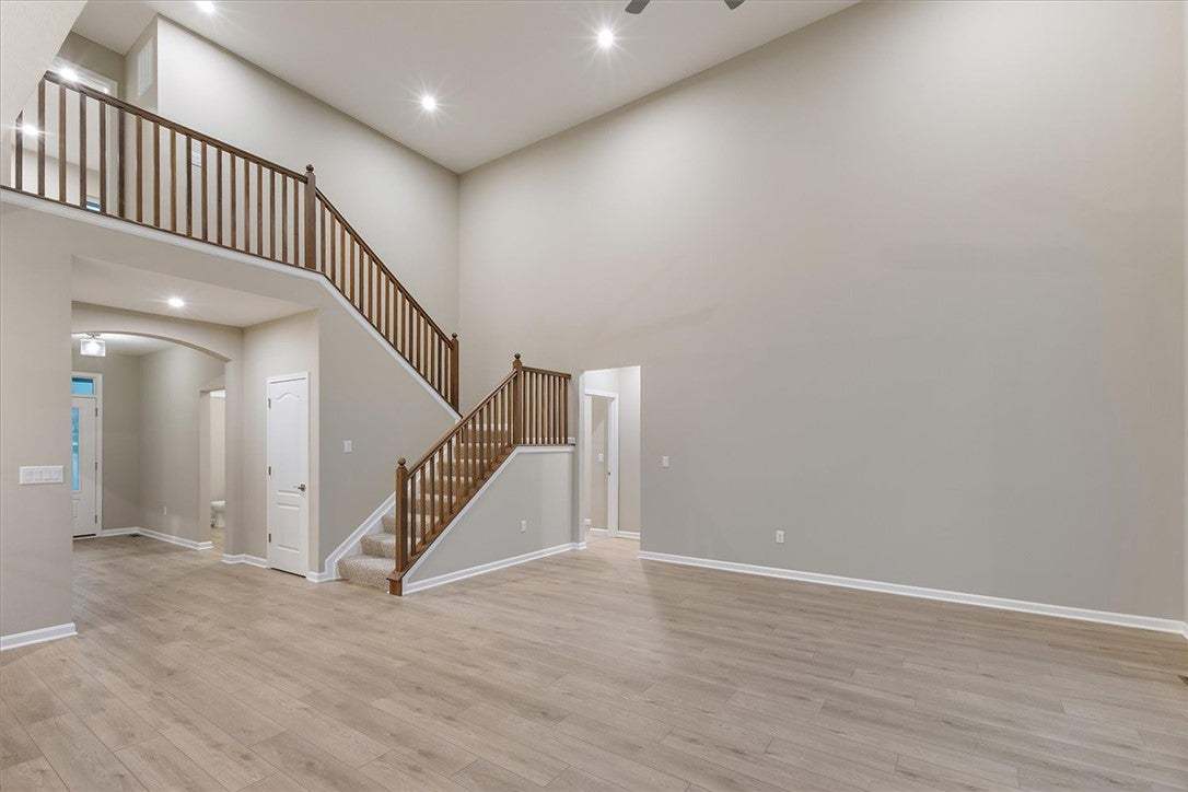 An open entryway showcases soaring ceilings and an
