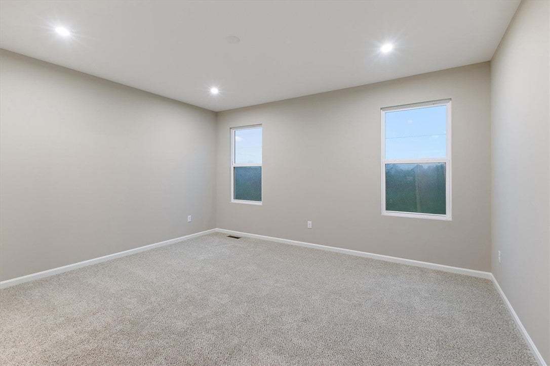 Recessed lighting and soft carpeting create a sere