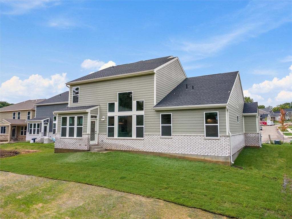 Multi-paned windows and mixed brick siding define
