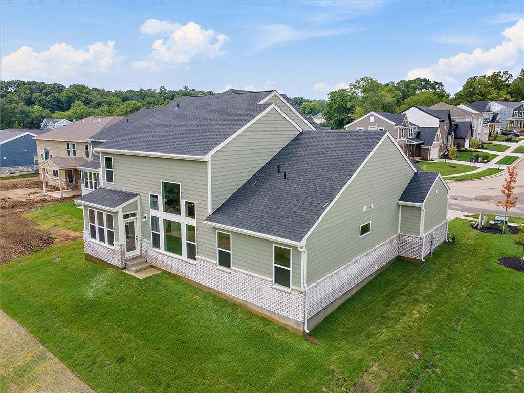A classic two-story siding and stone exterior sits