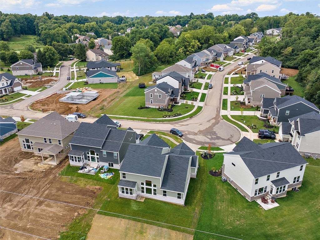 A winding suburban street connects modern multi-le