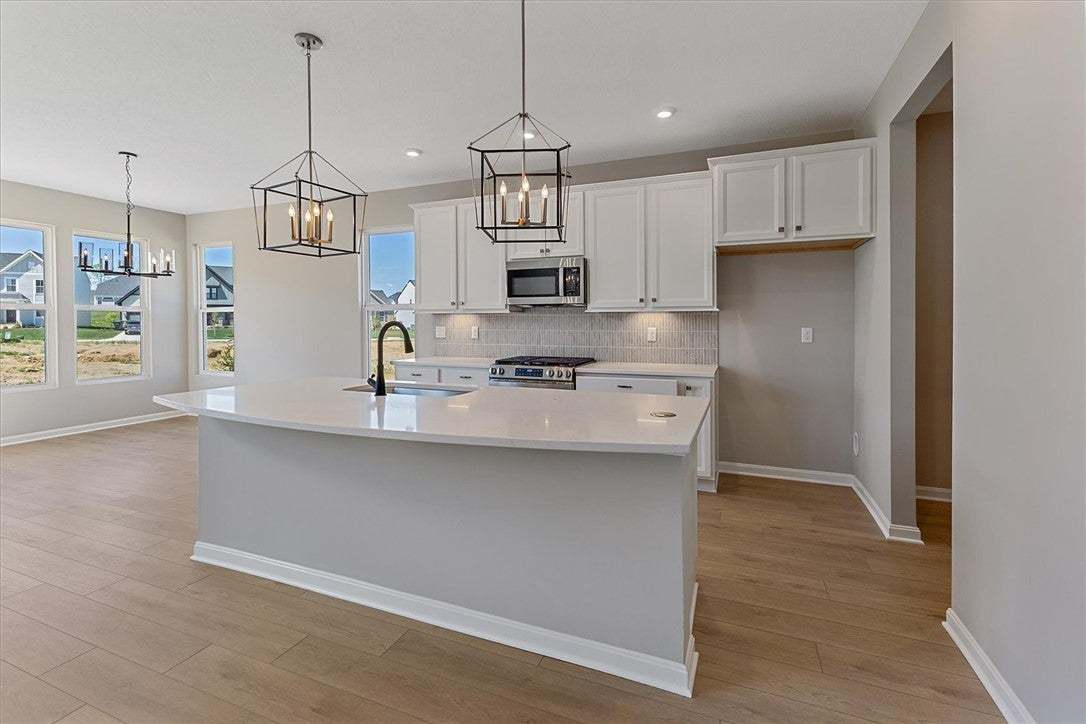 This bright kitchen features an island, ample cabi