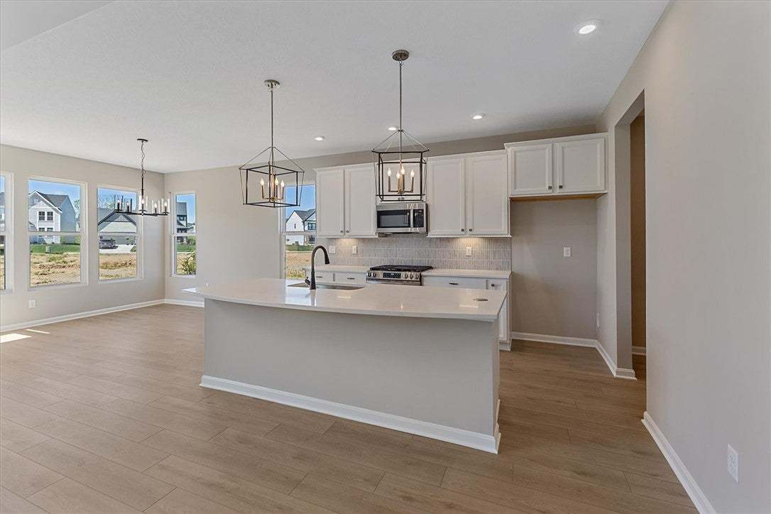 This kitchen features a central island, ample cabi