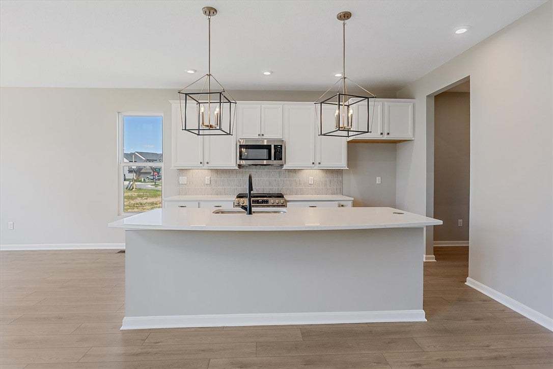 This bright kitchen features an island, ample cabi