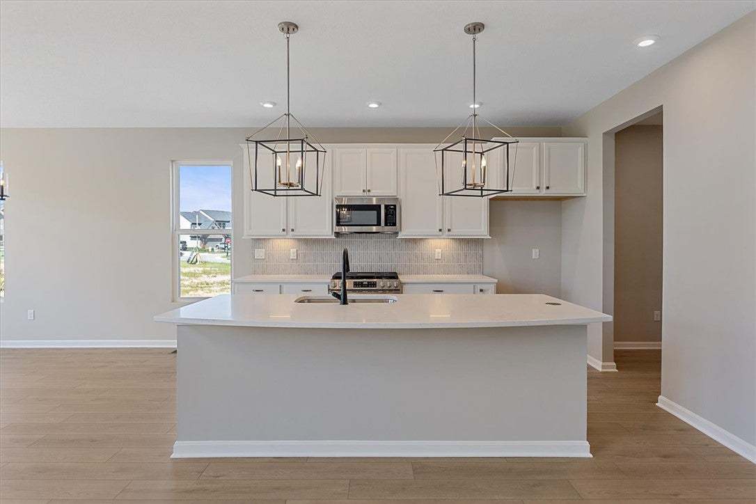 This bright kitchen features an island, ample coun