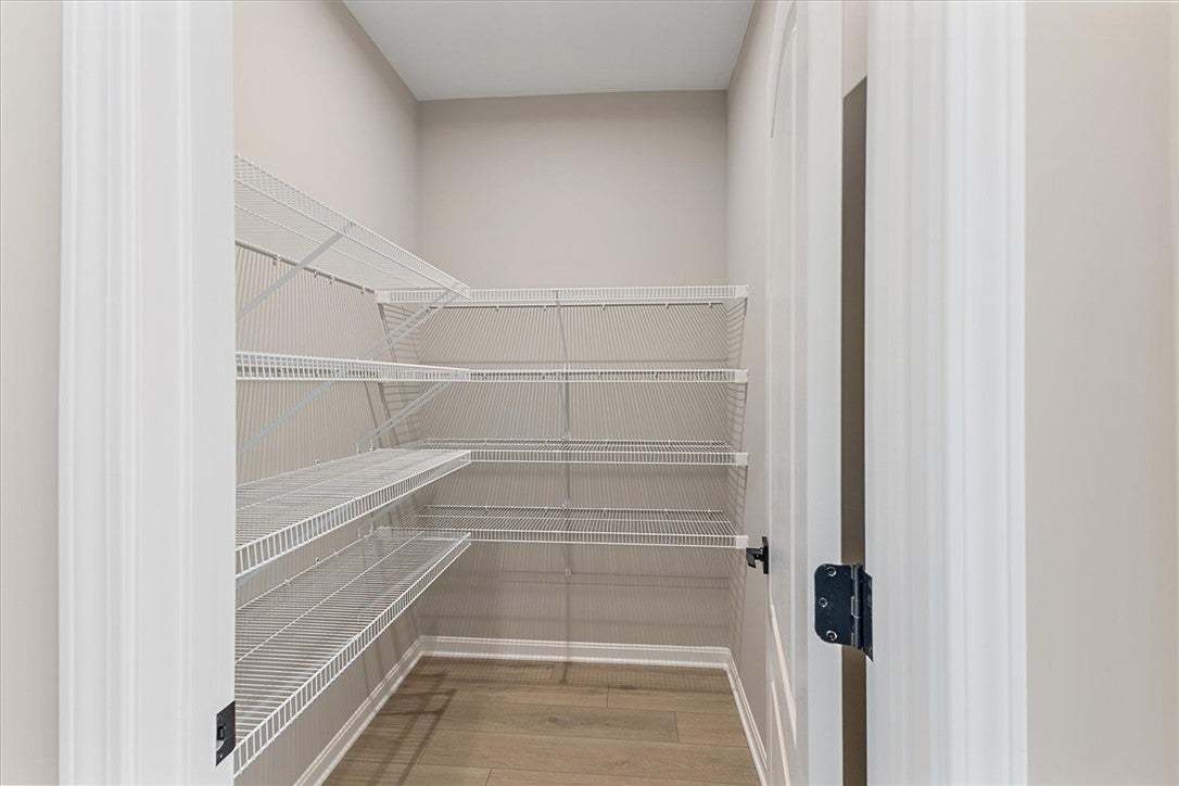 This spacious walk-in pantry provides ample storag
