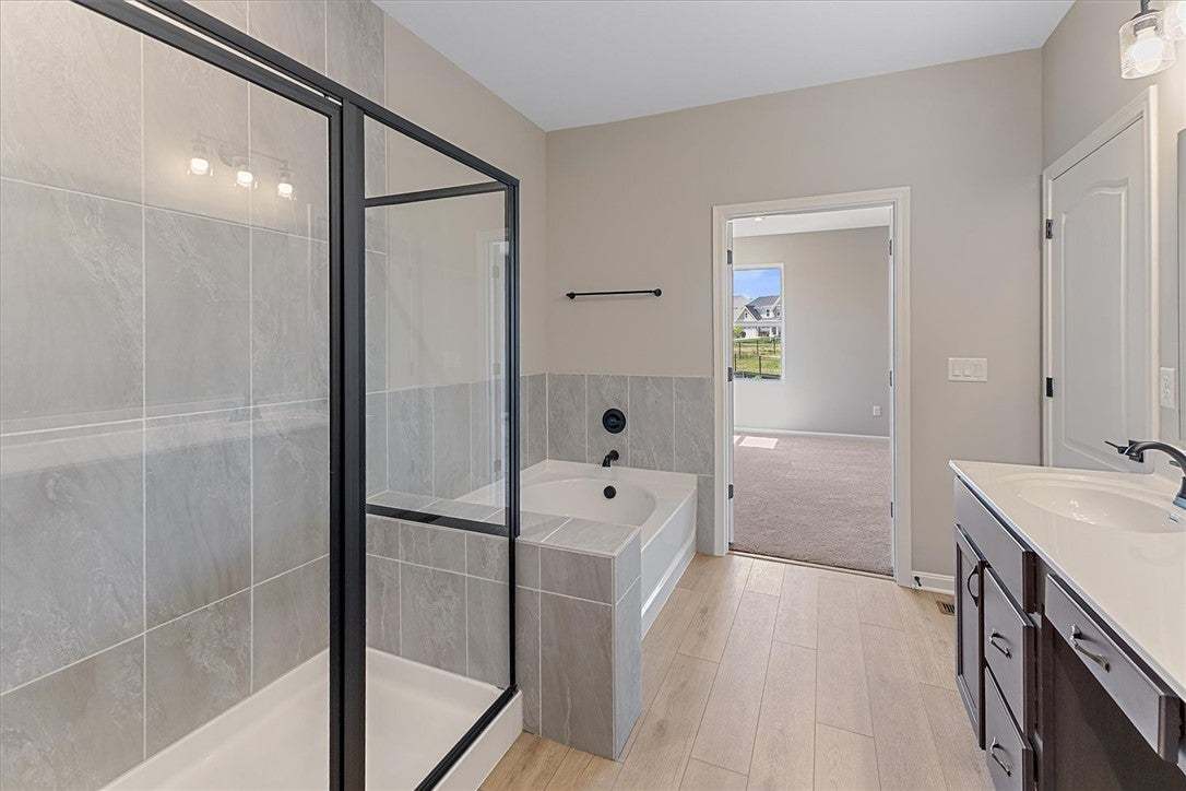 This serene bathroom offers a spacious walk-in sho