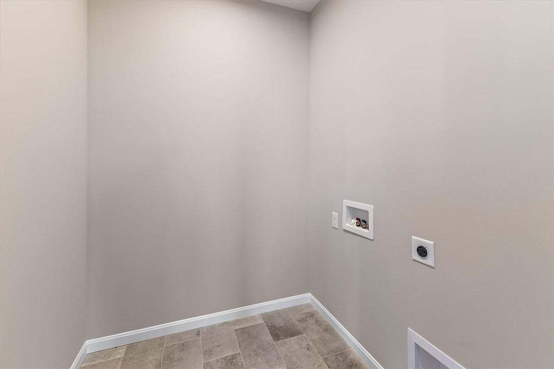 This dedicated laundry space features practical co