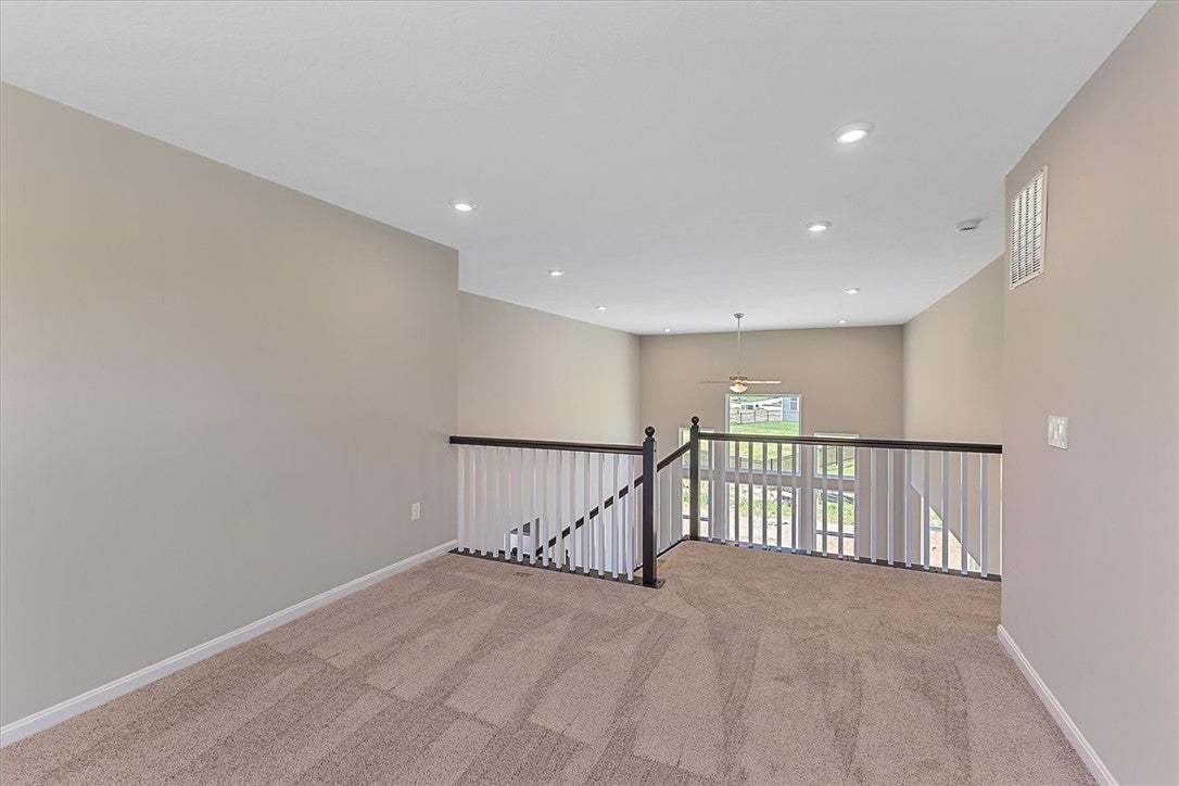 This versatile loft area, with soft carpeting, off