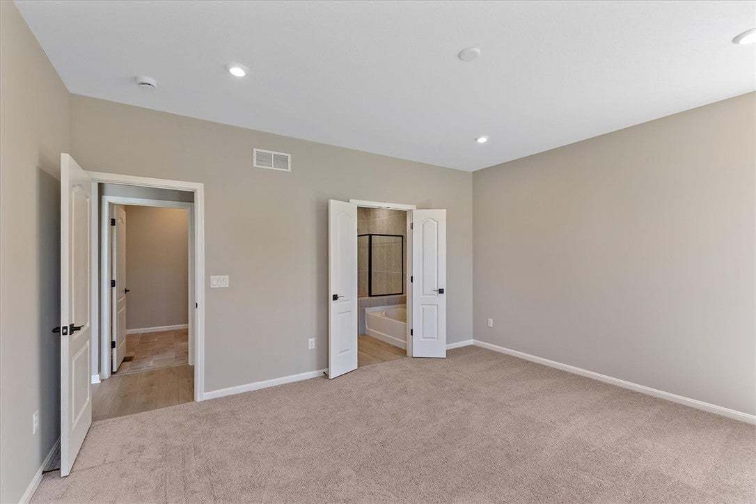 This spacious bedroom offers ample comfort and dir