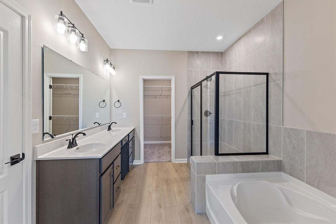 This spacious bathroom offers a double vanity, a s