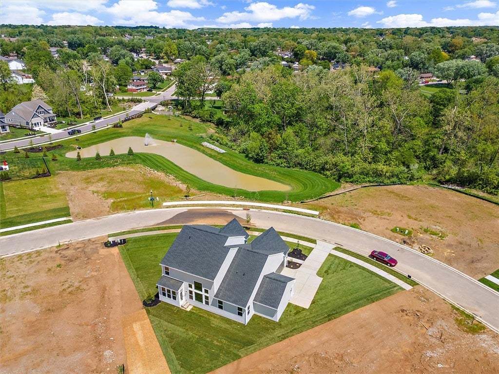 An aerial view captures a newly built home, windin