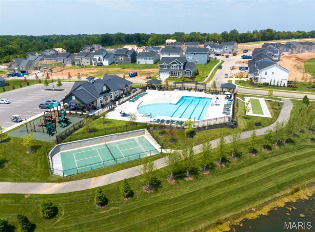 Aerial perspective of suburban area with a pool