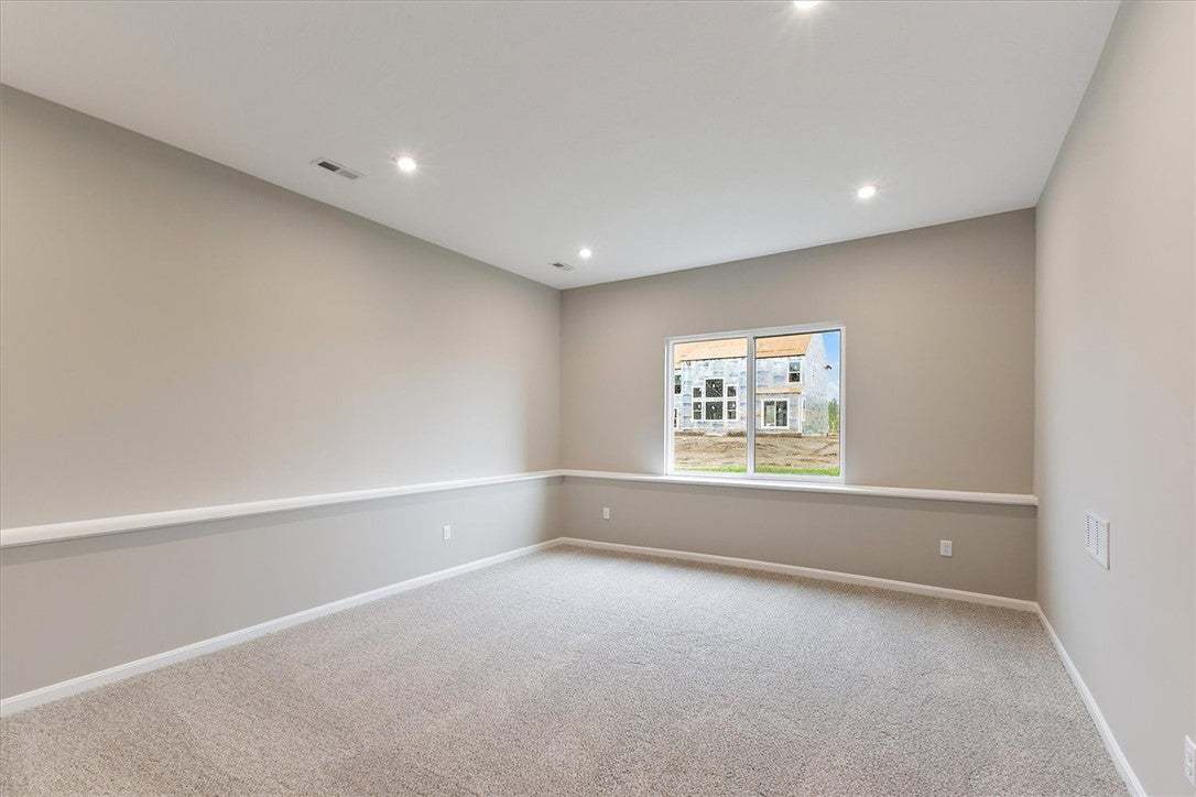 This versatile room offers ample space, bathed in