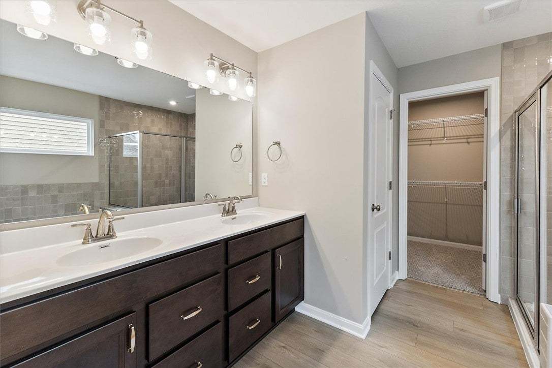 This spacious bathroom offers dual vanities and a