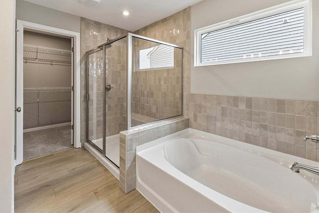 This primary bathroom boasts a spacious walk-in sh