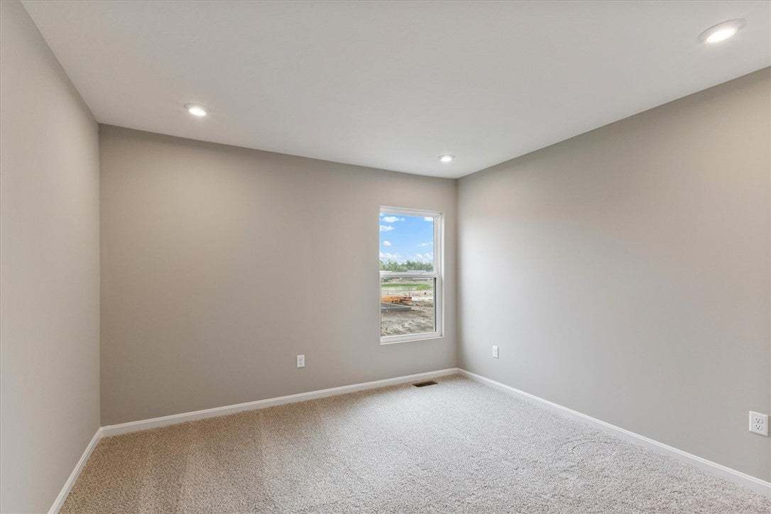 This bright and airy room features soft carpeting