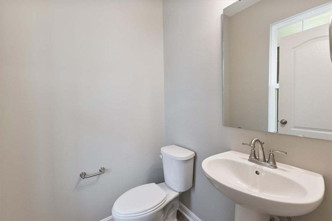 This clean and bright powder room features essenti