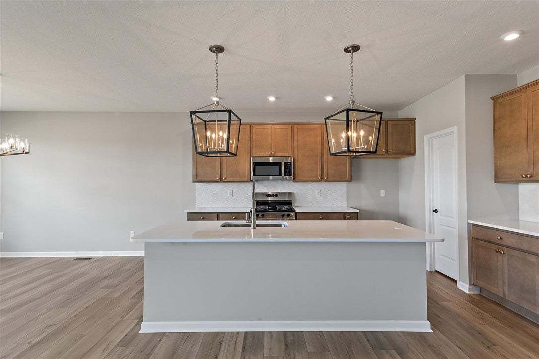 A well-lit kitchen presents a large island, perfec