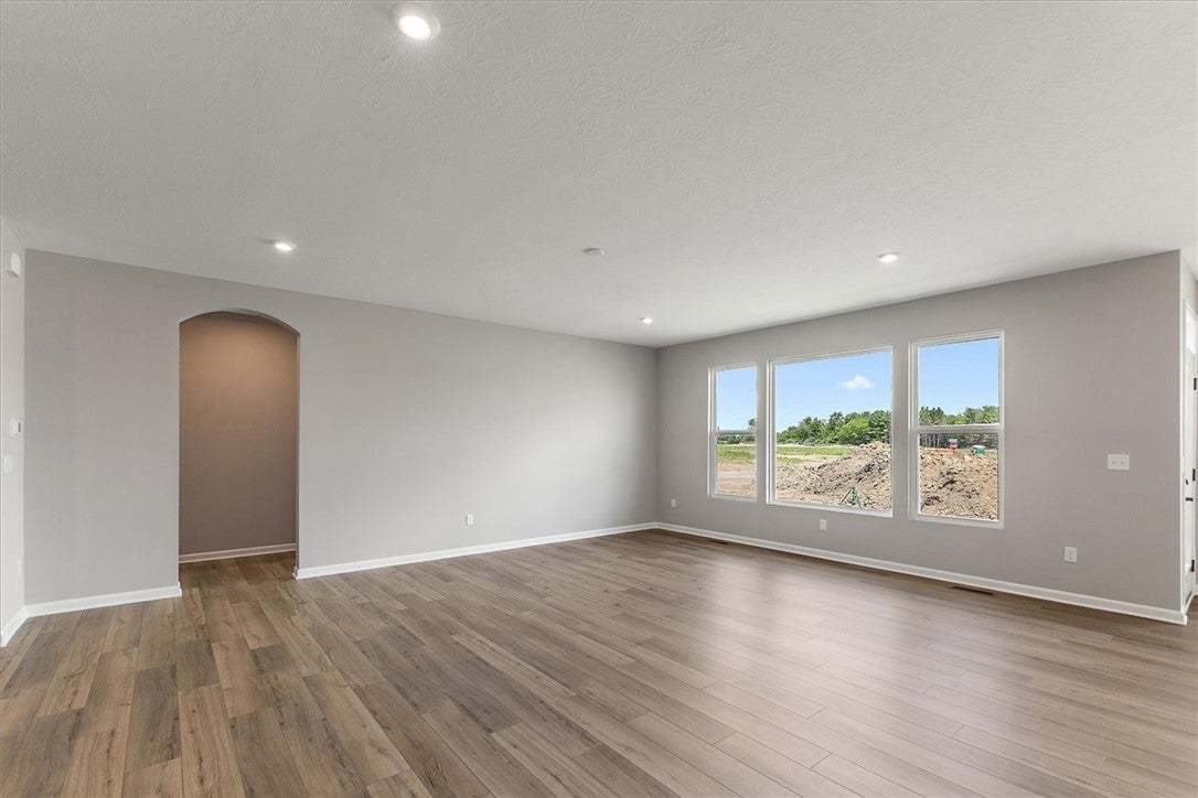 Recessed lighting illuminates the neutral walls an