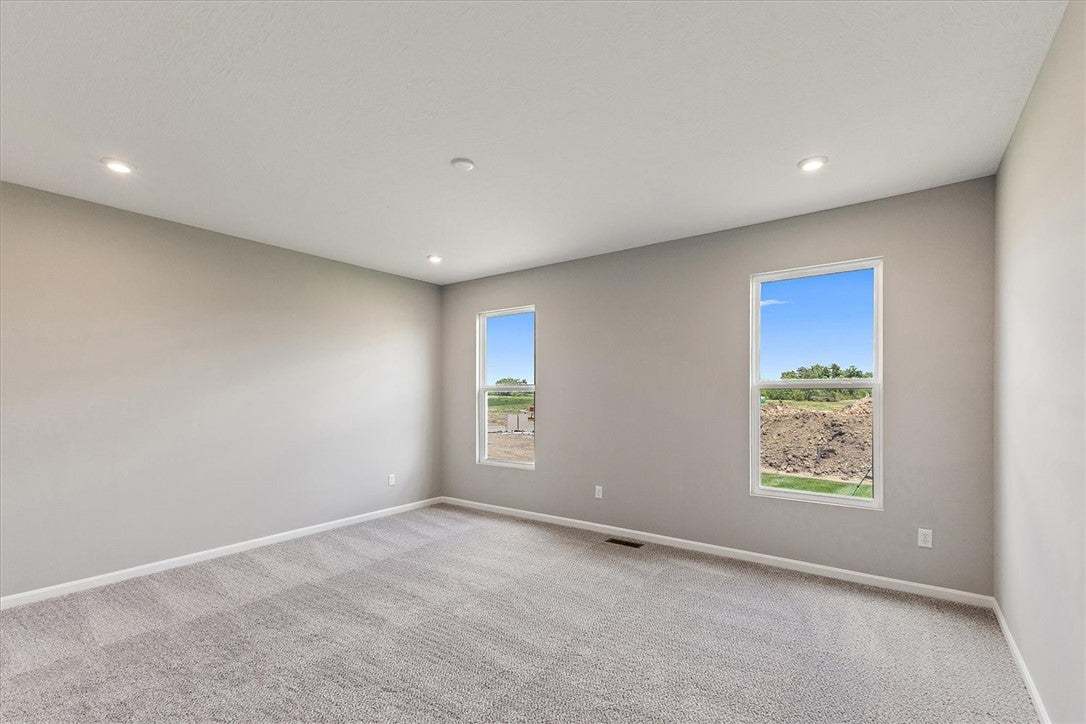 Recessed lighting illuminates this tranquil bedroo