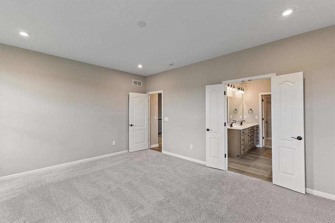 Recessed lighting illuminates this inviting primar